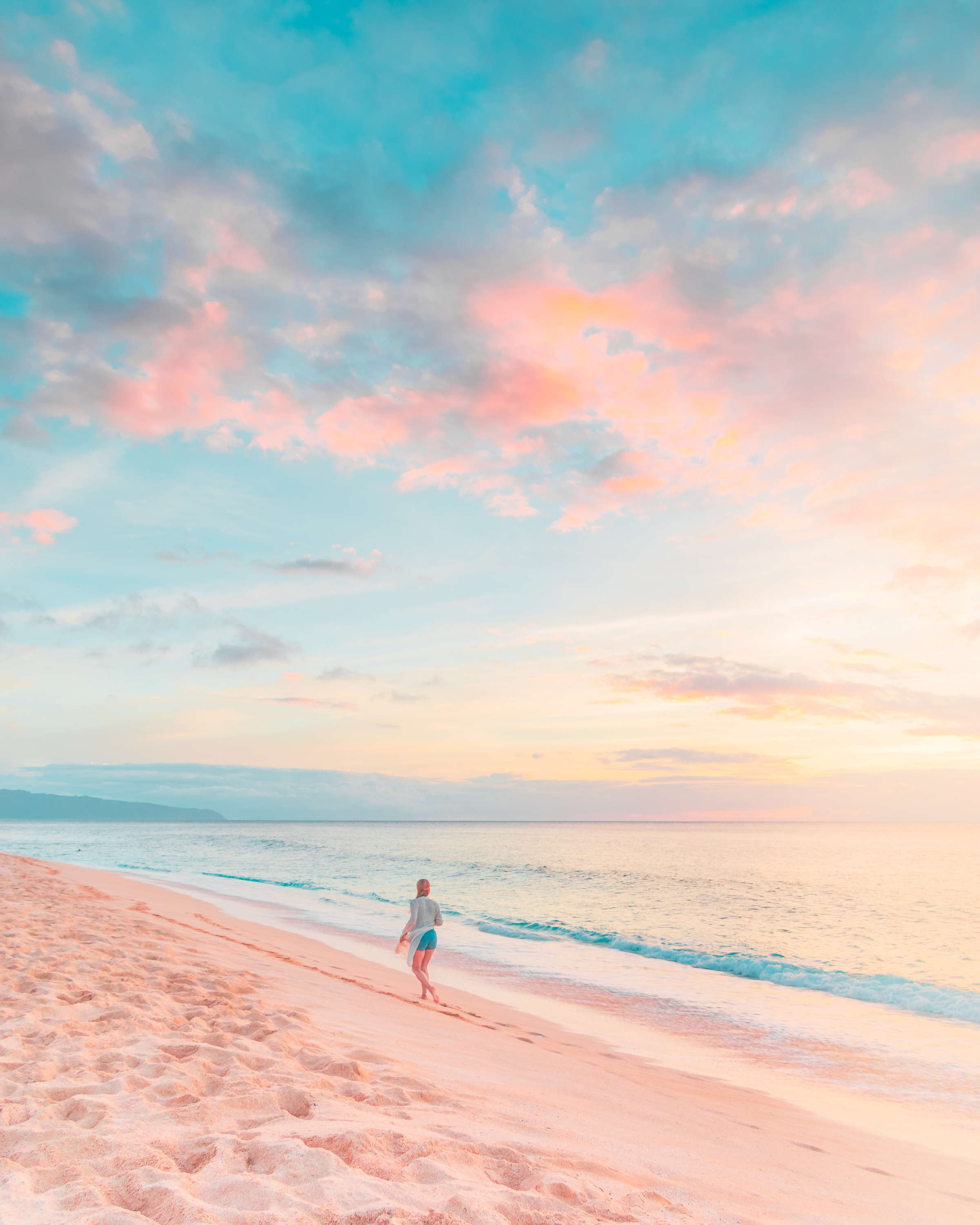 Woman in White Shirt Walking on Beach during Sunset